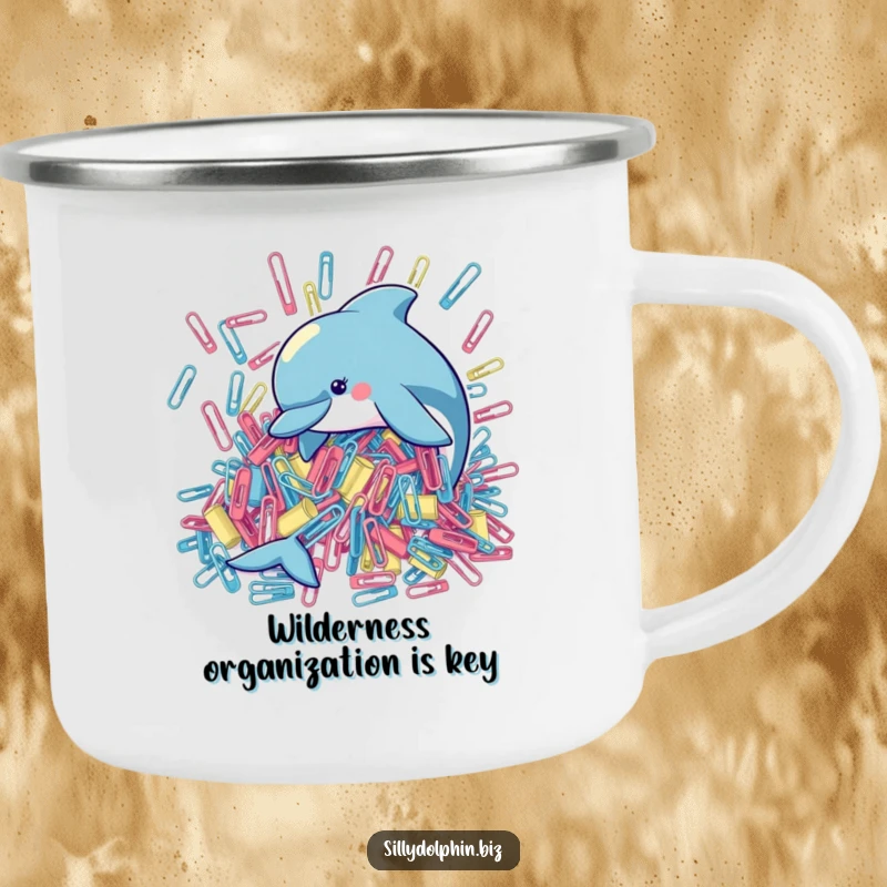 Funny camping mug depicting a dolphin diligently organizing a large pile of oversized paperclips, ideal for outdoor office humor.